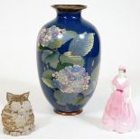An early 20thC enamel vase, of shouldered form decorated with flowers on a blue ground, 26cm H (AF),