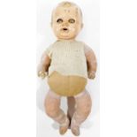 An early 20thC SUR doll, with pot head, articulated bisque limbs and material body with woollen shor