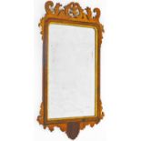 A 19thC mahogany fret mirror, in carved case with shaped glass, with gilt coloured moulded outline,