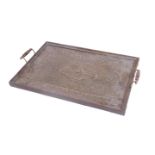 An early 20thC oak framed tray, with heavily hammered metal centre and shaped handles, 54cm W.