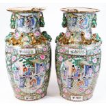 A large pair of Chinese Canton vases, each of shouldered form, decorated with panels of figures, wit