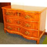 An early 19thC German walnut serpentine commode chest,