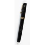 A Swan self filler fountain pen, in black with gilt banding and clip, swan to the top and 14ct nib,