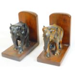 A pair of elephant bookends, on L shaped stands, tiger wood finish, 18cm H.