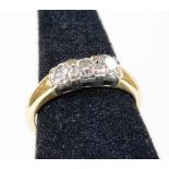 An 18ct gold three stone diamond ring, set with three round brilliant cut diamonds, in platinum sett