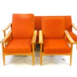 A vintage 1970s three piece lounge suite, comprising settee and two armchairs, each with turned legs