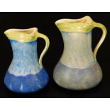 A graduated pair of mid 20thC Myott & Sons pottery jugs, no. 8509, each in blue and green striped pa
