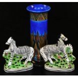 A Clews & Co Tunstall pottery vase, of cylindrical form, and two Staffordshire flat back figures of