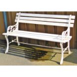 A railway type garden bench, with horizontal slats and wrought iron pierced ends and shaped feet, jo