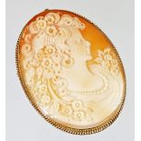 A 9ct gold framed shell cameo brooch, with oval cameo of maiden looking left, with flowing hair with