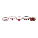 Five silver dress rings, each stone set with red, pink or white stones, of varying design to include