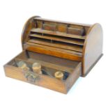 A 20thC oak desk tidy, of domed form with tambour top and front drawer, with fitted interior, 17cm H