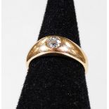 A diamond solitaire ring, with round brilliant cut stone in rub over setting, approx 0.2cts, on a ye