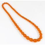 A modern imitation amber necklace, butterscotch beads, 32cm long.