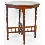 A Edwardian walnut stained window table, the octagonal top raised on turned legs, joined by a balust