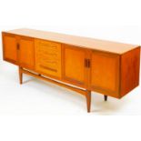 A vintage G-Plan teak sideboard, of rectangular form, centred by four cutlery drawers flanked by a p