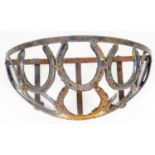 An early 20thC wrought iron planter or feeding trough, of D end form set with horseshoe design, 22cm