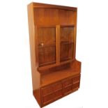 A Nathan style teak cabinet, with open shelf raised above two glazed doors with double cupboard bene