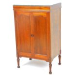 An early 20thC oak cabinet, with T N Knight Nottingham retailer's label, with double door front, on