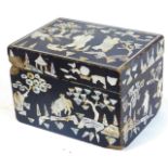 An oriental design mother of pearl box, of rectangular form with removable lid, profusely decorated