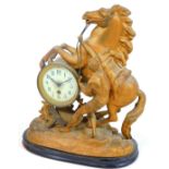 A 19thC spelter and gilt metal mantel clock, set with rearing horse and figure to his side, on a roc