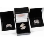 Three modern silver dress rings, comprising of two modern Pandora floral wedding type bands, one set