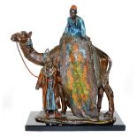 A cast and painted spelter figural table lighter, in the manner of Bergmann, formed as an Arabian ru