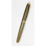 A Parker 75 fountain pen, in textured gilt and black lattice work colours with gilt clip and circula