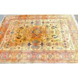 A large 20thC Indian carpet, set with floral and geometric medallions, predominantly in red blue and