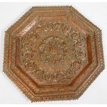 A late 19thC Indian or Burmese octagonal copper plaque, with pierced and raised border, the centre w