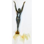 A 1930s Art Deco metal figure of a nude lady, with arms upright, on a shaped base with partial glaze