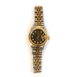 A ladys Rolex date adjust bi-metal wristwatch, oyster perpetual baton pointers and shaped numerals s