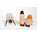 A Beswick Laurel and Hardy cruet, 13cm H and a Beswick match striker of a gentleman with mouth open.