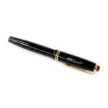 A Montblanc 244 fountain pen, in black with gilt clip and banding, No.4 nib. 12cm W.