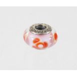 A Pandora charm, in the form of a bead, with pale pink interior and red flowers, marked 925 ALE, 3.4