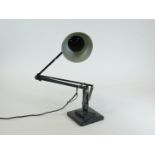 A vintage Bauhaus style angle poise lamp, in black with cone shaped shade, on a square base, 15cm x