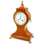 A 19thC mahogany balloon clock, the shaped case on an inverted stem and platform base, terminating i