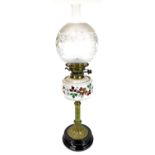 A late 19thC oil lamp, with clear and frosted glass shade, clear funnel and glass reservoir, on a tu