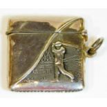 An early 20thC vesta case, raised with golfer with side ring handle and match strike base, marked St