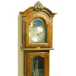 An oak finish longcase clock, with scroll and shell hood, arched glass door and panel base, 22cm arc