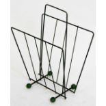 A retro wire work metal newspaper rack, with orb feet in green and black, 42cm H.