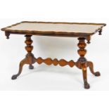 A mid 20thC walnut coffee table, with piecrust edge raised on double baluster columns joined by a ho