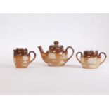 An early 20thC Royal Doulton stoneware three piece miniature tea service, with silver rims, comprisi