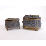 A matched graduated pair of French caskets, each of oval form raised with classical figures, interio