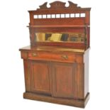 A late Victorian mahogany chiffonier, of small proportion, the carved top raised above an arrangemen