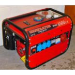 A Super Silent 6500CX generator, 6.5k VA, in red with black cage, 45cm H, 56cm W, 46cm D.