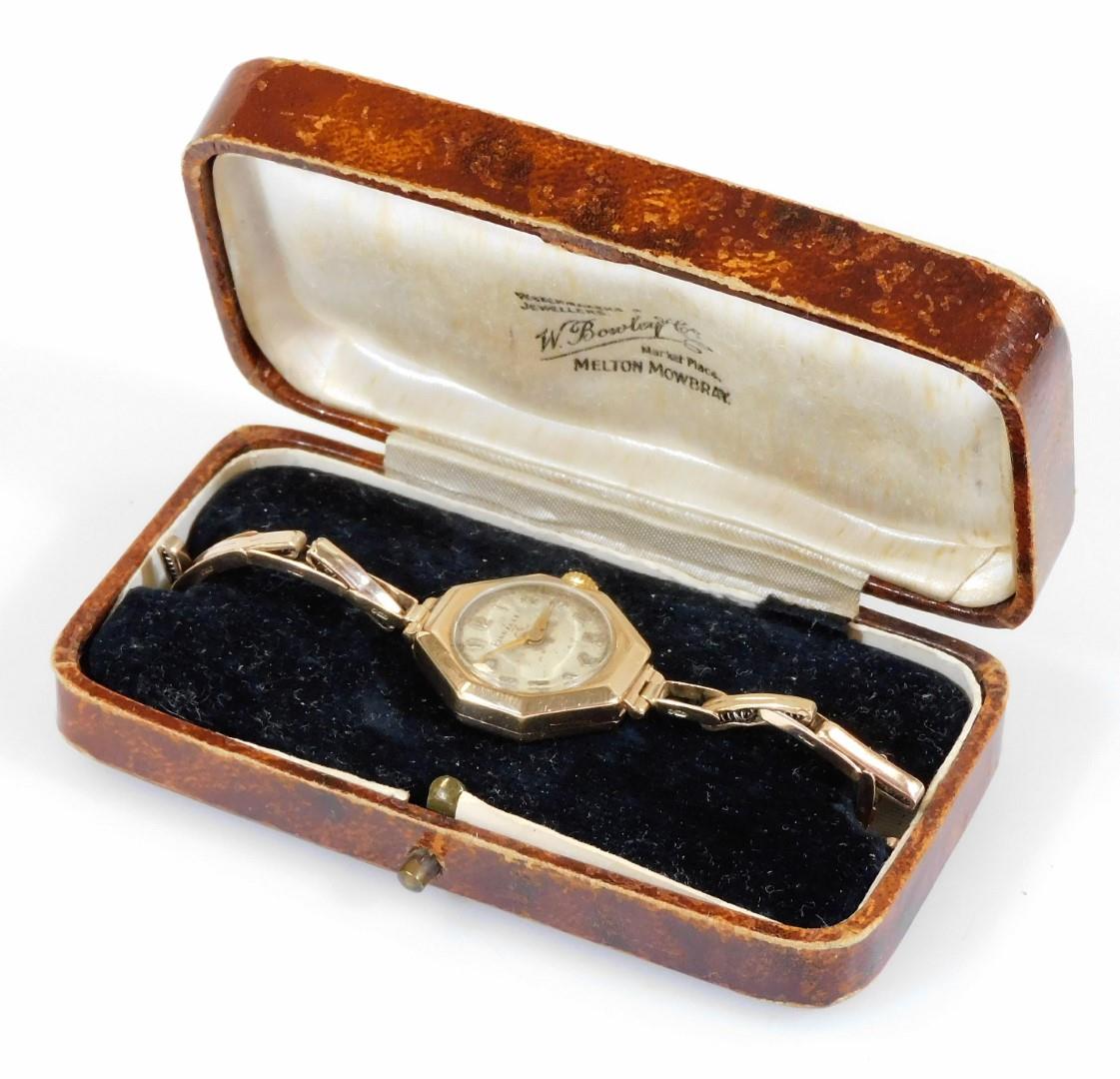 A 9ct gold Pinnacle ladies wristwatch, with octagonal watch head, on a silvered circular dial, on ex