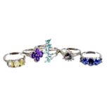 Five modern silver dress rings, each stone set with various coloured stones in clusters and five row