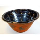 A large pottery pancheon, of circular form, the interior glazed in black, 56cm Dia.