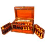 A late 19thC mahogany cased games compendium, containing chess set in the Staunton style with 7.5cm